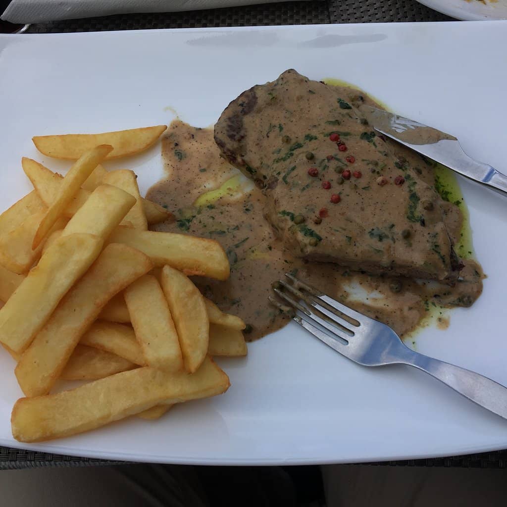 Steak with sauce and fries