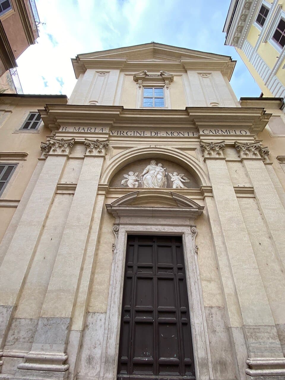 Façade  The façade by Michelangelo Specchi was completed in 1750. It's in the Late Baroque (tardobarocco) style, and has two storeys. After the recent restoration, the colour scheme is white on pale yellow but it used to be white on orange ochre.