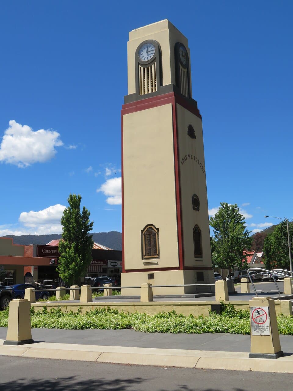 Clock tower of contrasting colours and straight lines. Looking towards Ireland Street. WW1 plaque  features. 