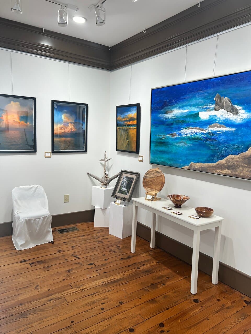 Wow! Those painting in the background by Tom Gonzalez look like photographs! He's taking over our gallery with his solo exhibit in November 2024. Come see his amazing pieces!