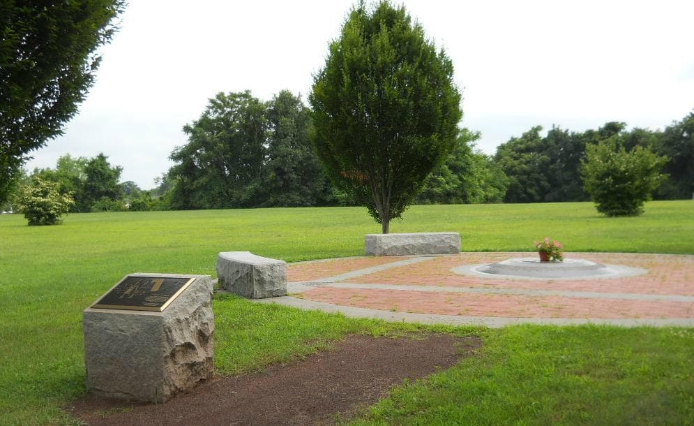 Partial view of the monument; there's a fresh bouquet in the center.