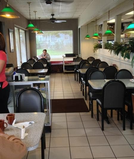 Tables near front entrance (north) & kitchen to the right.