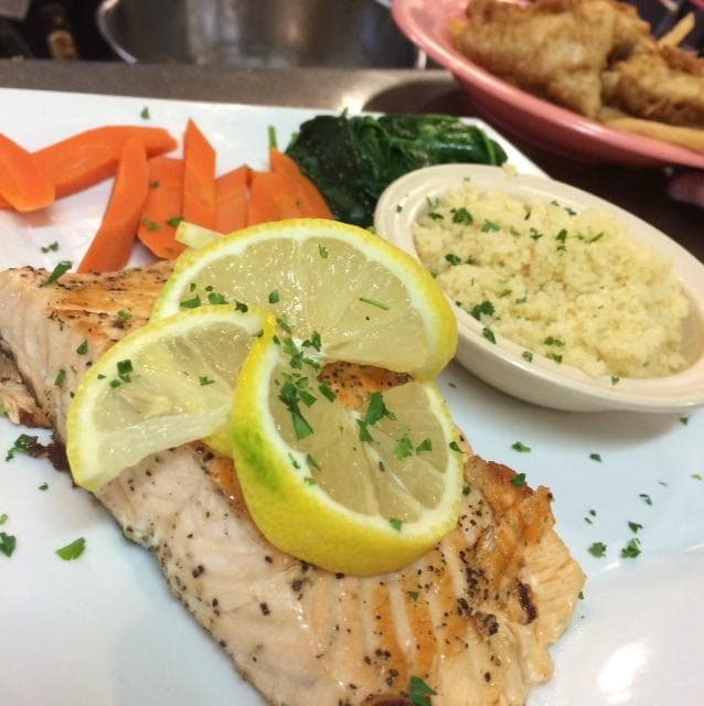 Grilled salmon, steamed carrots, sauteed spinach and couscous