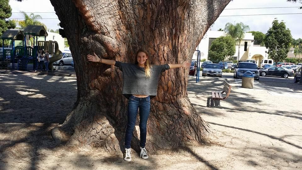 Playing under one of the large trees in the Park