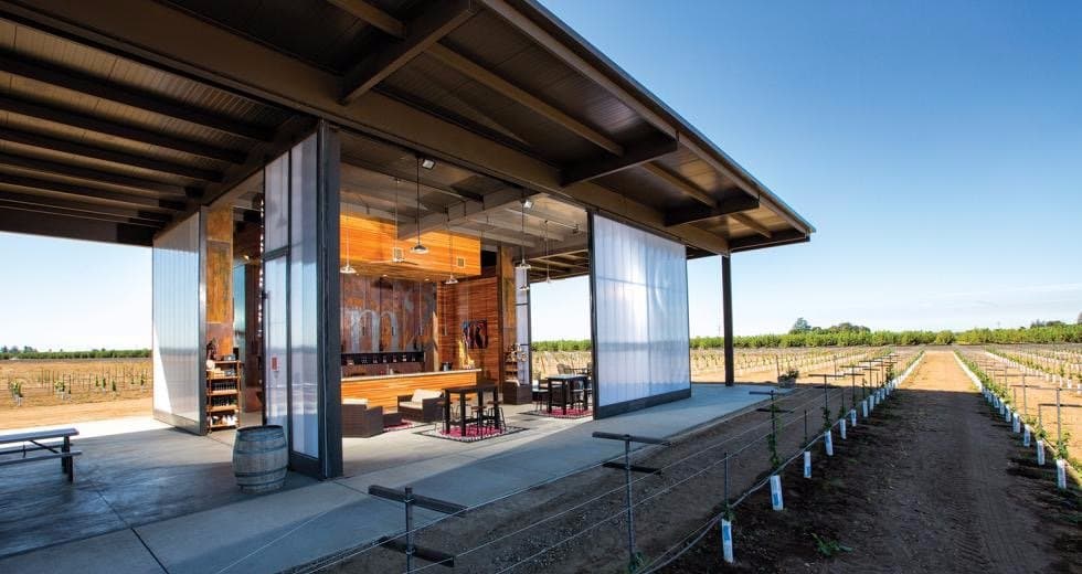 The open walls of our tasting room let you enjoy tasting in the vineyards.
