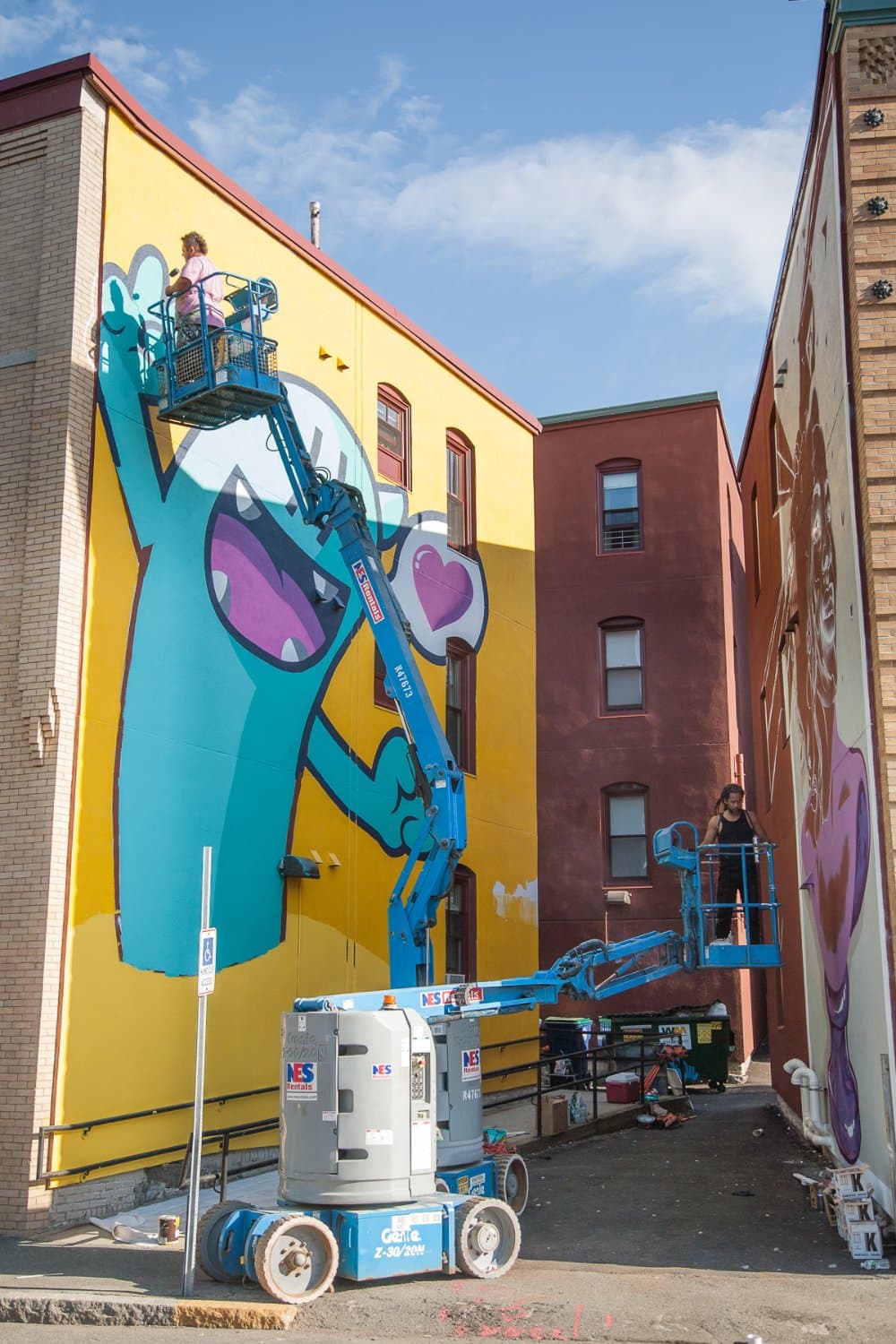 Golden and Ruben Ubiera painting on Peabody Street.