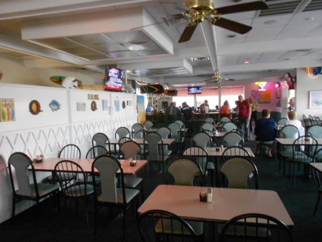 Dining area with bar in the background.