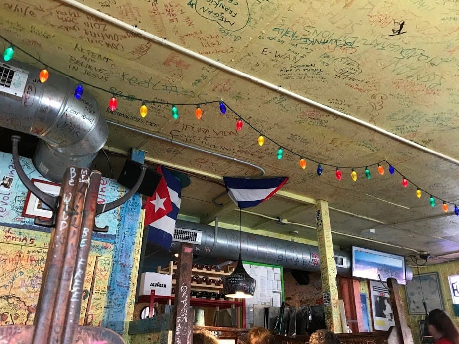 inside dining area-patrons' messages and handy arts covered walls, ceiling, pillars and lamps