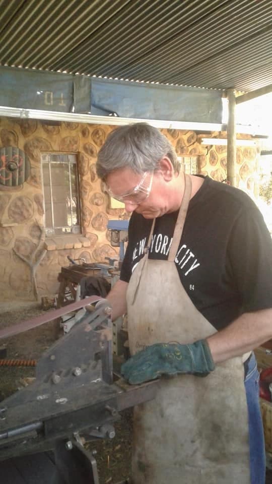 Working on smoothing and sharpening the knife