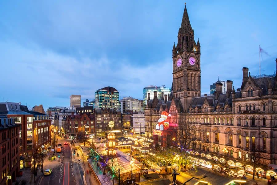The famous Manchester Christmas Markets in Albert Square with 'Zippy' overlooking the festivities from the Town Hall.