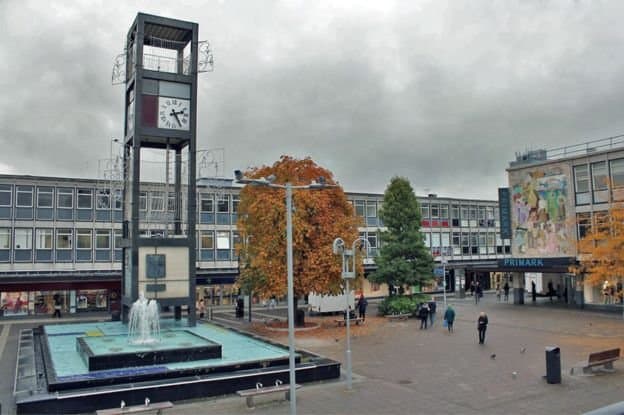 New Town Fountain & Clock Tower, with ugly concrete buildings in the background.