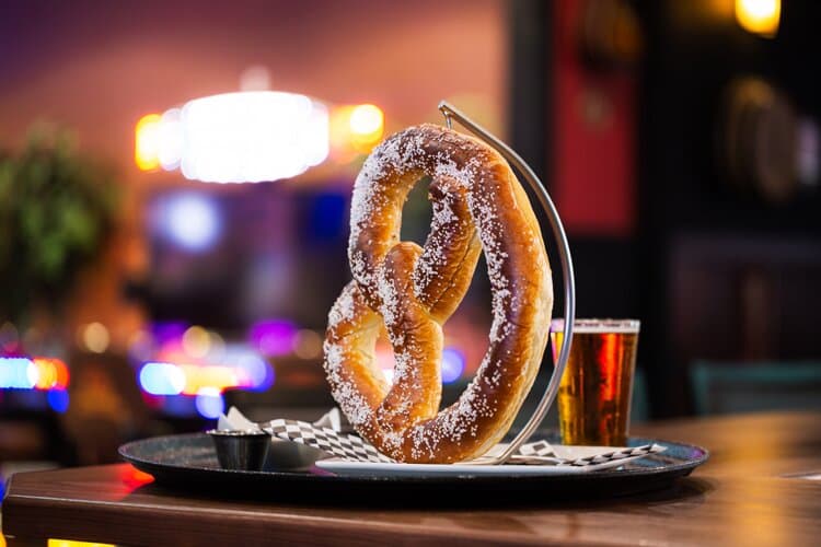 The Grand Pretzel: salt-crusted, oven baked pretzel served with beer cheese and spicy mustard sauce.