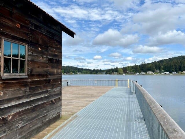 Pier with netshed and picnic tables.
