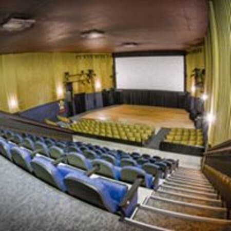 Stadium seating, hardwood stage, theatrical lighting, surround sound, digital projection and always fresh popcorn