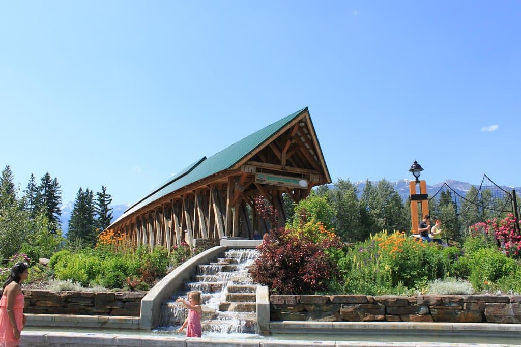 The gardens and waterfall next to the bridge