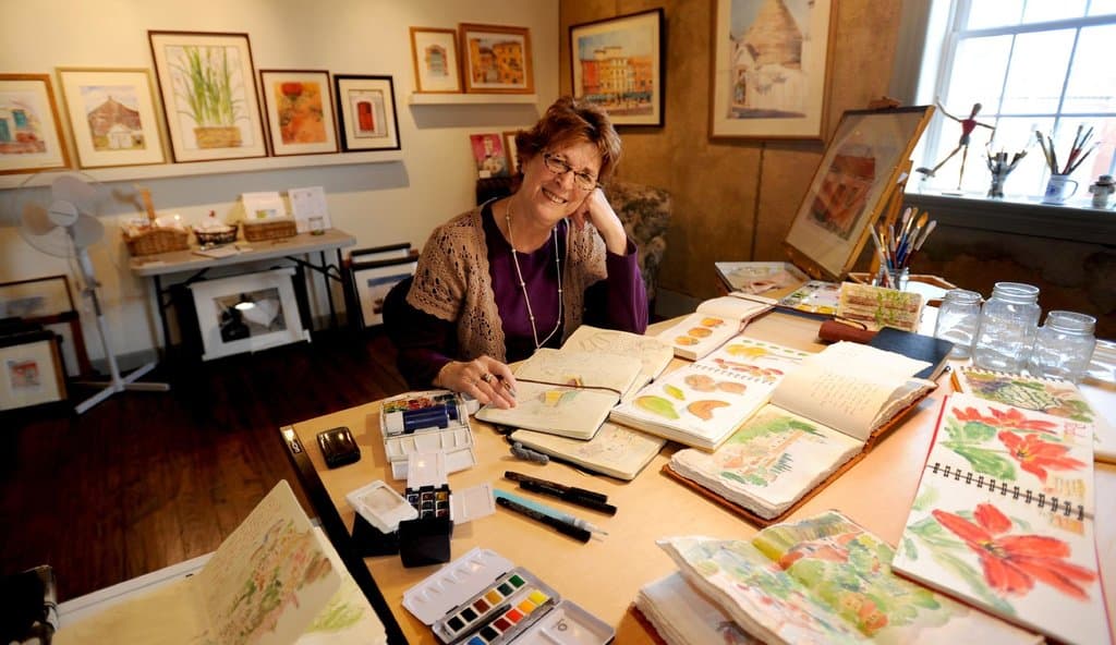 Rosemary with her journals, Live Cheap and Make Art Studios.