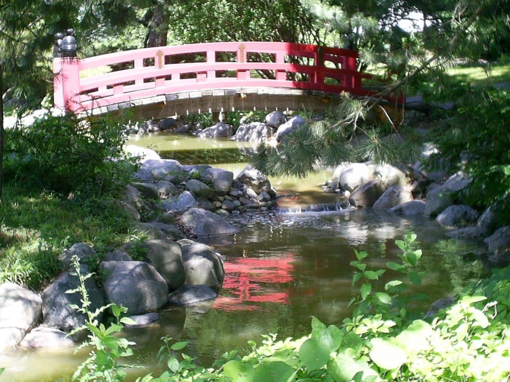 Red footbridge over our flowing stream