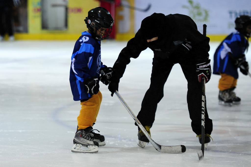 Coaching kids in hockey school @ Abu Dhabi Ice Rink taken by Fatima Al Ali
