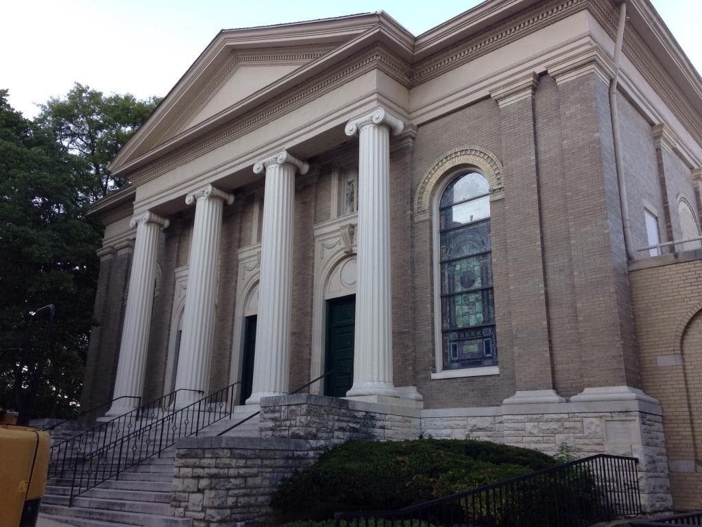 Dark green doors into the narthex between the big columns
