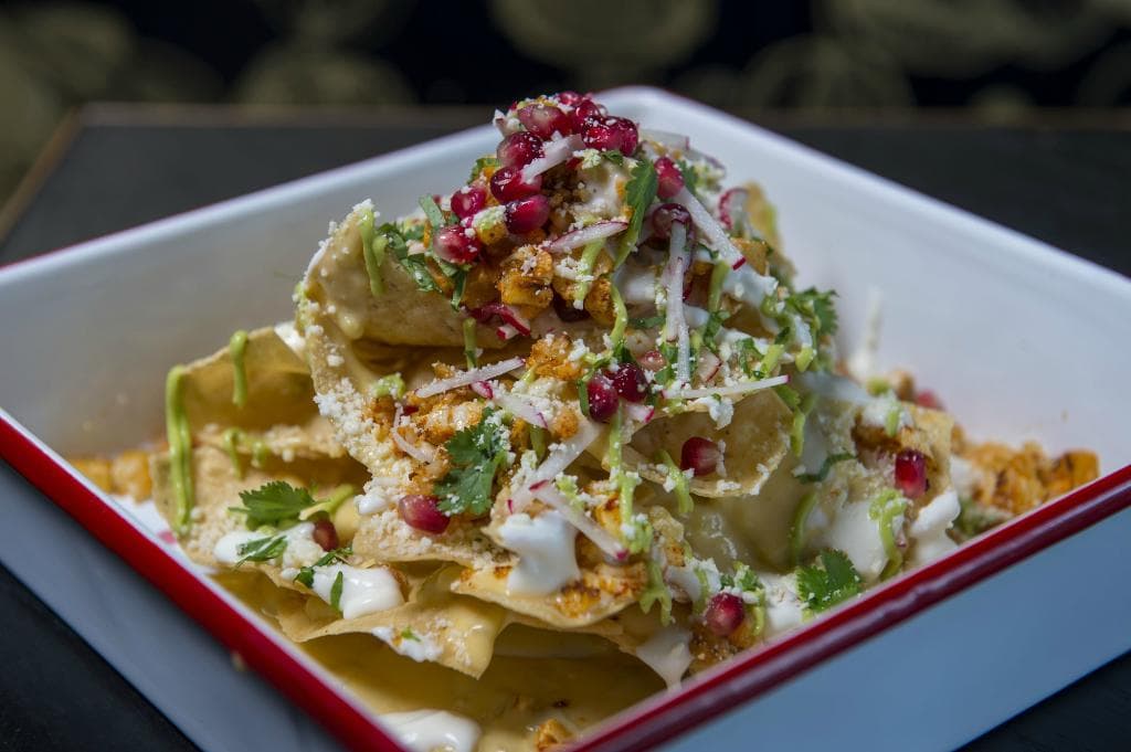 Cauliflower Nachos - 3 cheese blend, pomegranate, radish, avocado, cilantro, & green chilies