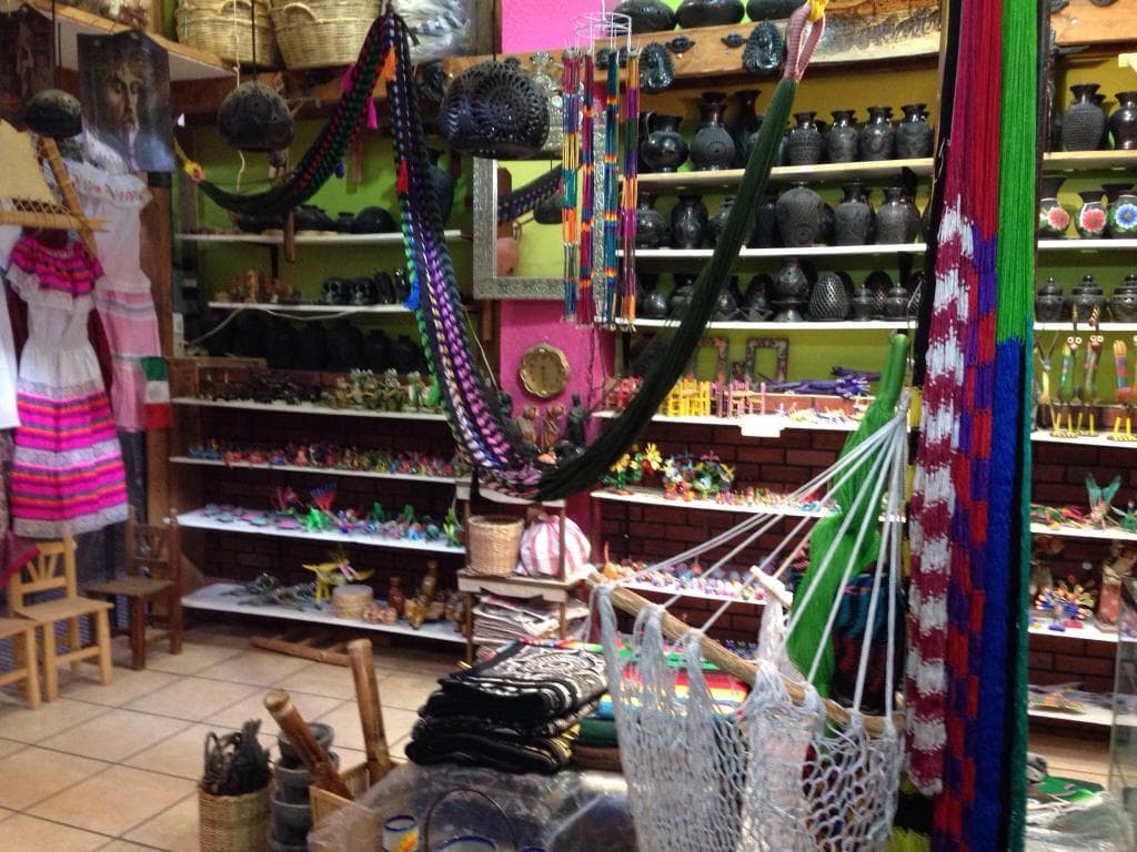Juan sells Alibrijes (beautiful Oaxaca wood carvings), barro negro (Oaxaca black clay pottery) a
