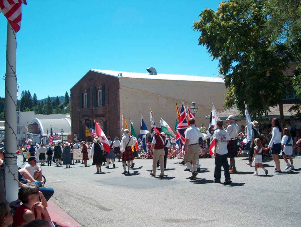 Parade marchers on the 4th of July with the brick theater in the back.