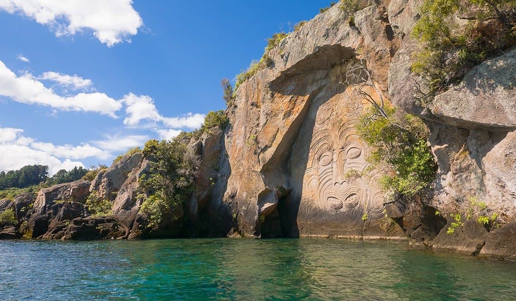 The main face with smaller carvings to the left