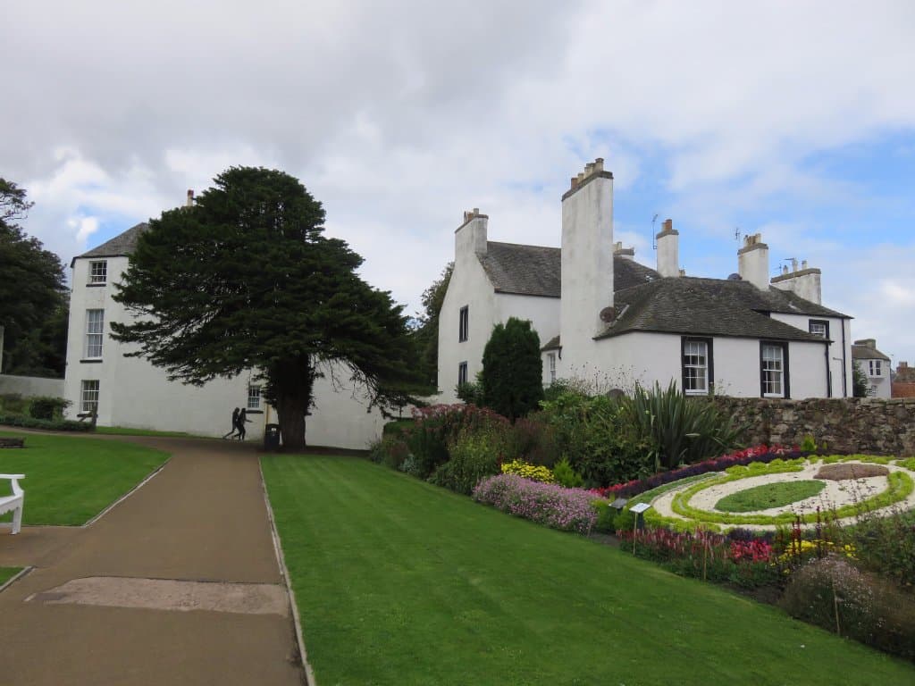 clock with Lodge and Hightower house in the background