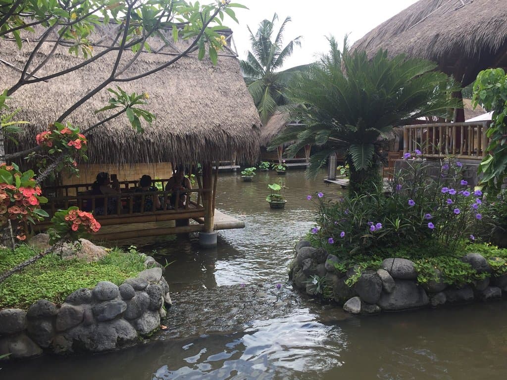 Huts on the fishpond. Also tables inside the main restaurant.