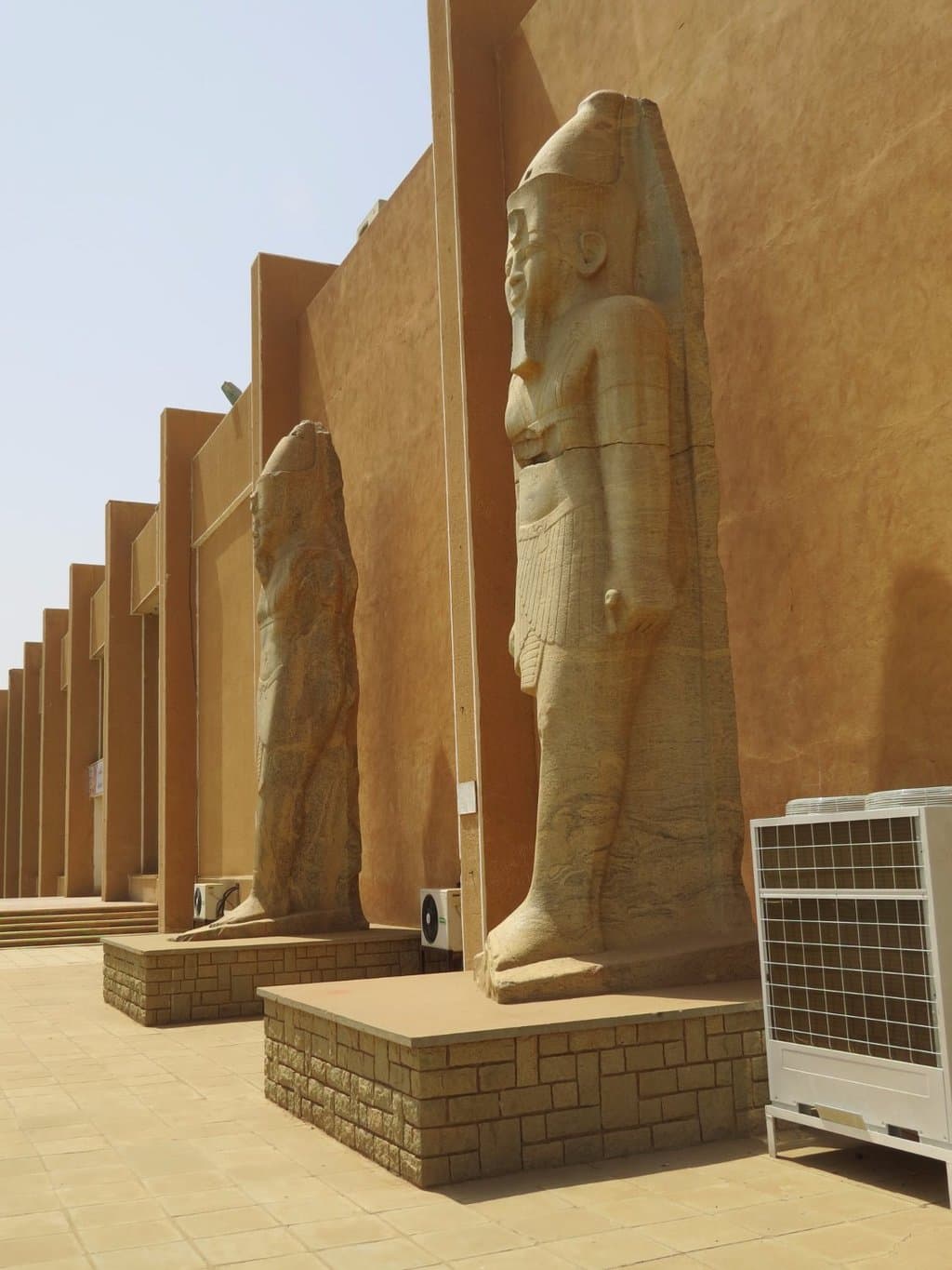 giant statues of guardians, in front of museum