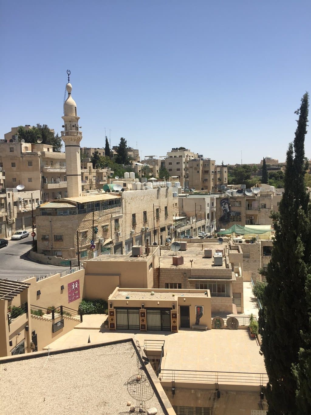 Looking down onto the street, main villa that houses the gallery, and terrace