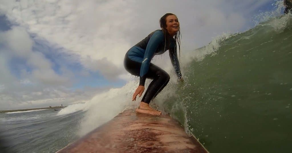Vahine, the founder of Cold Hawaii Surf Camp, enjoying a beautiful wave in Klitmoller