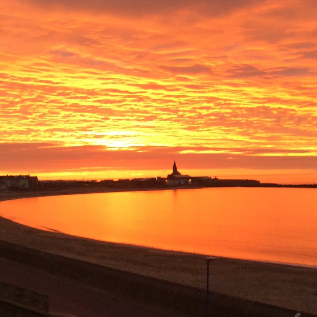Sunrise behind Newbiggin Maritime Centre