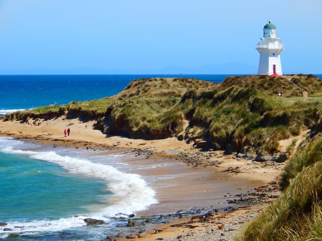 The light house dominates the cliffs above the beach