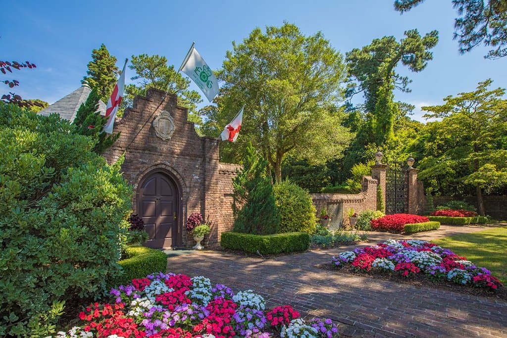 Our entrance gatehouse framed by summer blooms.