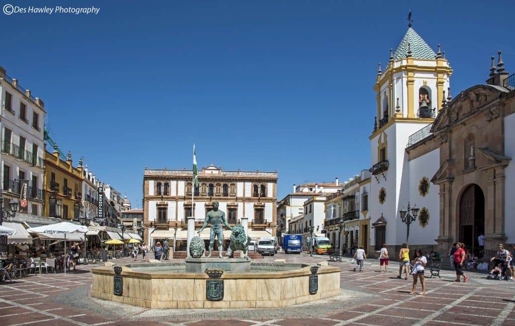 Hercules and his two lions with various restaurants on the left hand side.