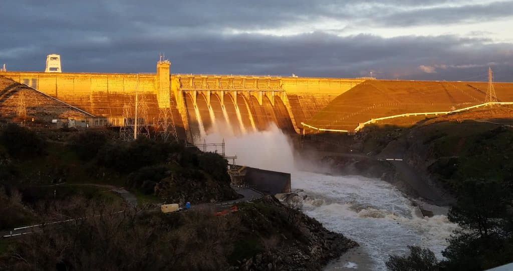 Gray Folsom Dam turns golden in March at sunset