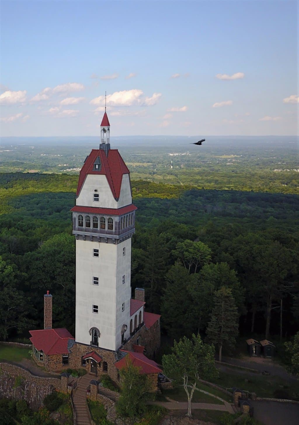 Aerial view of Heublein Tower, Hartford is visible in the background.