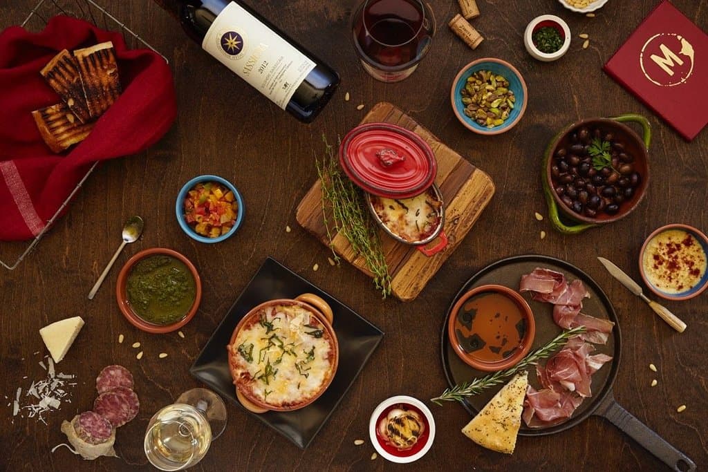 assortment of goodies: Lasagna, Eggplant, Prosciutto, Creme Brulee. 