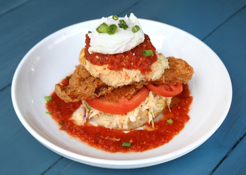 Catfish Biscuit with slaw, fresh tomato, a poached egg topped with tomato creole gravy