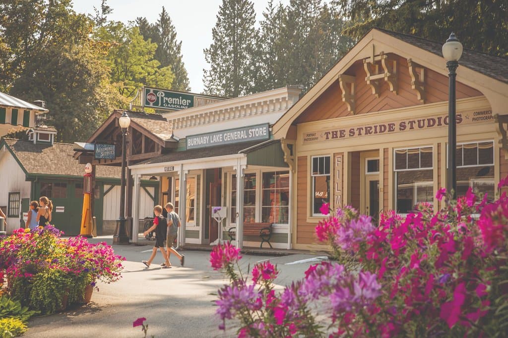 Rounding the corner to Hill St - the main street in the village. Visitors are invited into: the Stride Studios to see the latest collection display, the General Store to browse the merchandise of the day, and into the Royal Oak Garage to see the tools and parts were used to keep the old cars on the road.