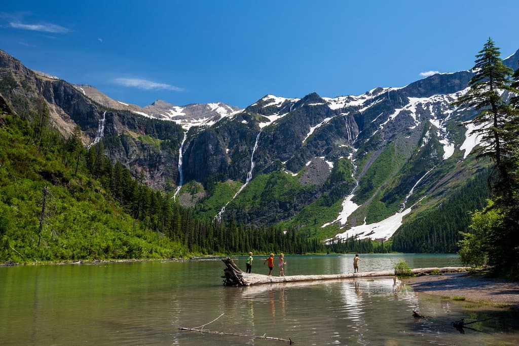Hike two miles through the Trail of the Cedars and along a creek to get to Avalanche Lake on the west side of Glacier National Park. Because of its low elevation, this trail is one of the first to open for the summer season in May.  https://www.yellowstonepark.com/tag/glacier-national-park