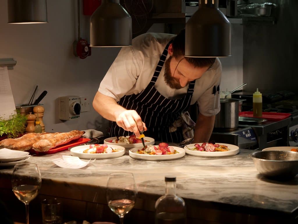 Plating up at the pass. Sit at the Chef's table and you get to watch the whole show.