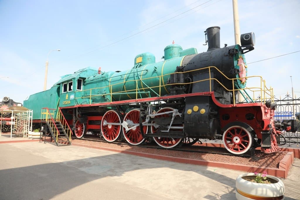 One of the locomotives at the entrance with steps allowing you to climb up to see inside the cab.