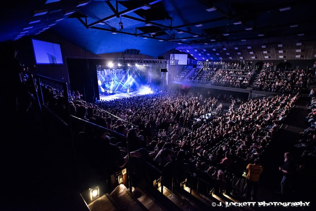 Our venue accommodates over 2,000 people seated, and 2,200 with a GA pit for large rock and country shows. The room can also be scaled down to 1,100. 

When the facility is hosting trade shows and business expos, or hosting a nightclub-style event, the seats are removed on the main floor and the balcony sections are raised, allowing the entire area to be used for display space, exhibits, or entertaining. 