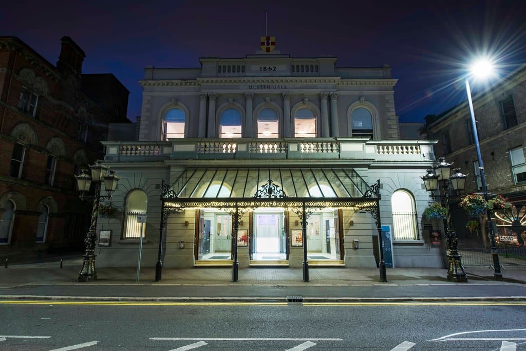 A frontal view of the exterior of the Ulster Hall taken in the evening. 