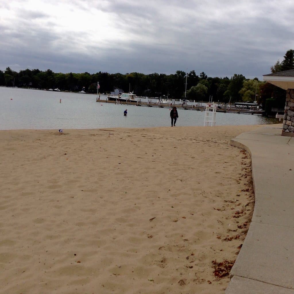 Beach, boat storage, one lone swimmer this September day