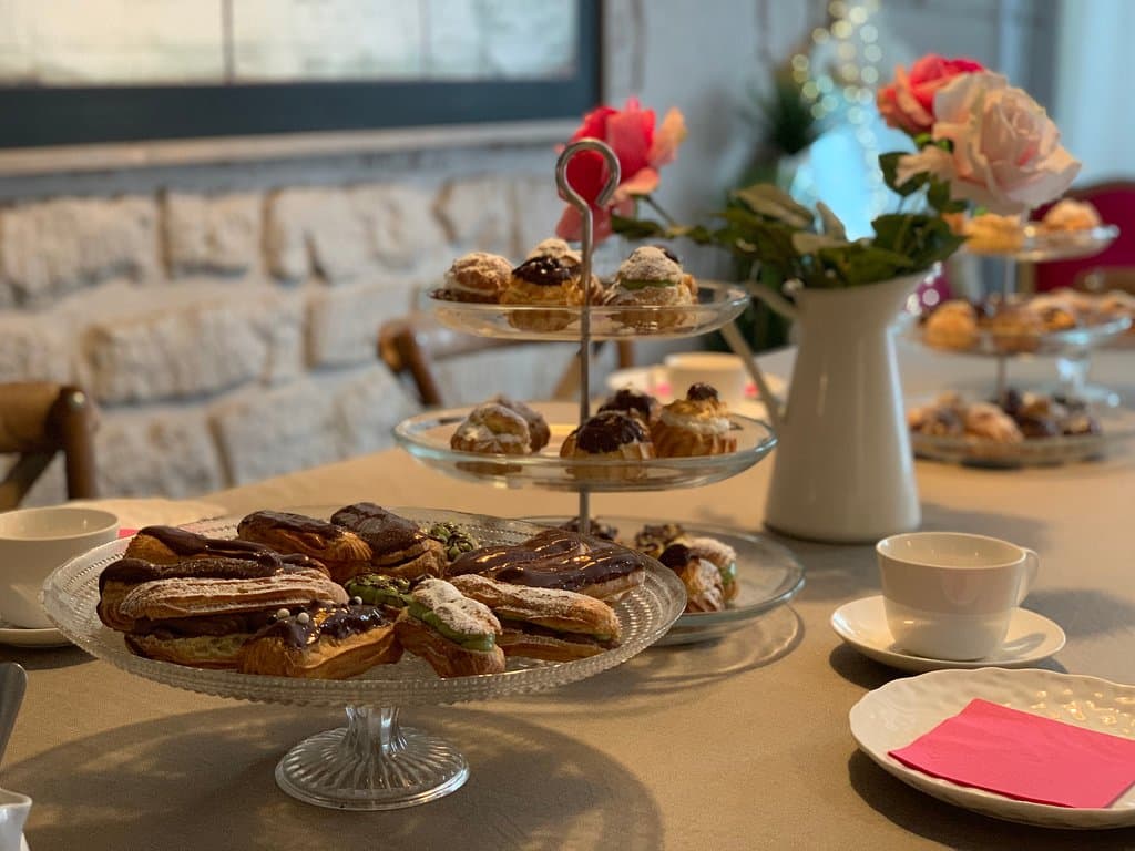Teatime with Chocolate Eclairs and cream puffs 
