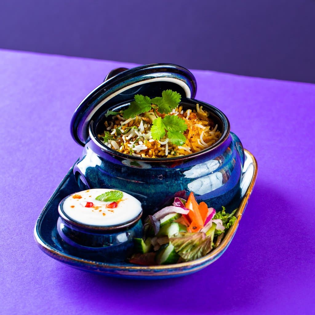 The traditional biryani roots back to Persian culture (it was later brought to India by the Mughals). Layered rice typically cooked with chicken, lamb, or vegetables, biryani is best enjoyed with a generous dollop of raitha (yoghurt-based condiment) and a hearty smile.