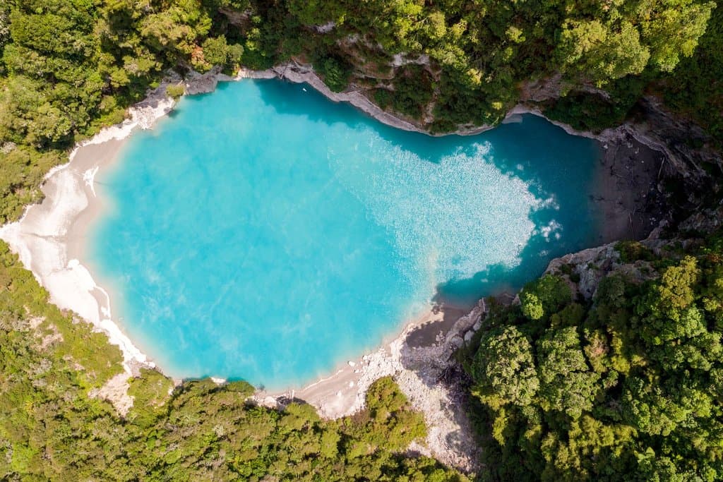 Inferno Crater at Waimangu Volcanic Valley. This geothermal attraction features a crypto-geyser, an underwater geyser that causes the lake levels to rise, fall and overflow on a cycle.